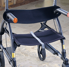 A detachable walker backrest support connected to an UPWalker upright walker.
