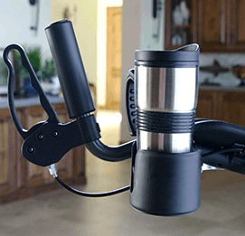 Walker drink holder attachment connected to a walker handle with a silver travel mug.